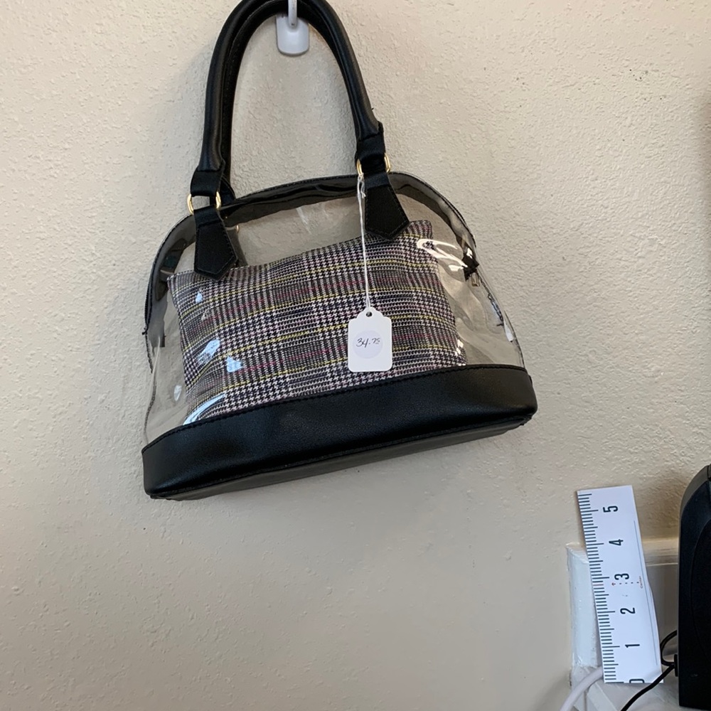 Small clear bag with small makeup bag inside.  NWT